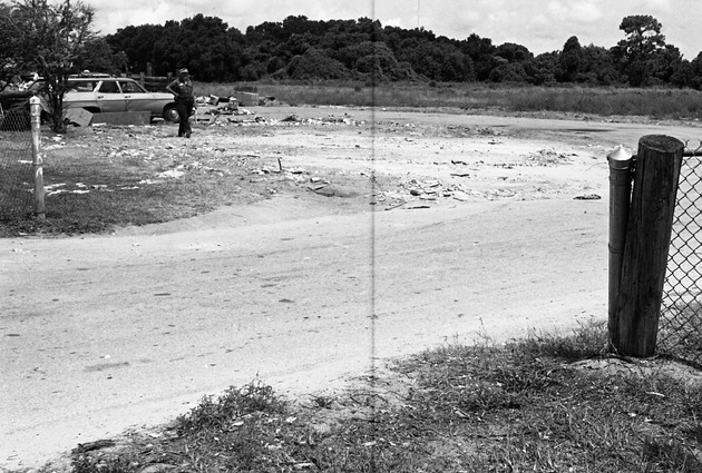 Metropolitan Dade County West Division's trash station - Negative: [View of unpaved path and an individual]