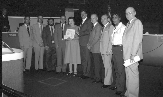 Miami Beach City officials and employees during various events and presentation of awards, 1980s - Negative: [View of officials presenting awards inside the Commission Chambers]