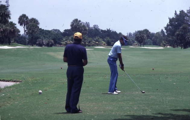 Men playing on Miami Beach golf course, 1982 - Slide: [View of two men playing golf]