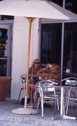 Two women outside Xando Coffee on Collins Avenue