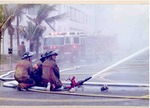 Fire fighters using a fire hose