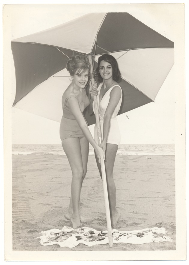 Bobbi Shaw and Corinna Tsopei  - beach modeling scene - Recto Photograph