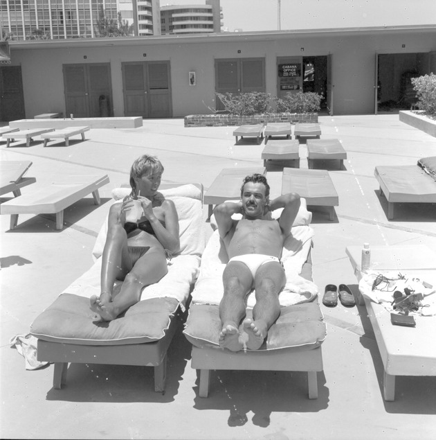 People sunbathing - View of two people sunbathing