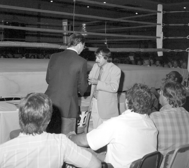 Bruce Singer beside a boxing ring, presentation for Florida Sunshine State Golden Gloves Week - Bruce Singer and unidentified men in front of a boxing ring