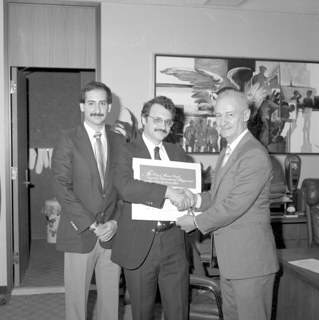 Abe Resnick giving certificates to an unknown man, and honorary citizenship certificates to Chikako Ota and Miyako Ota - Image 1