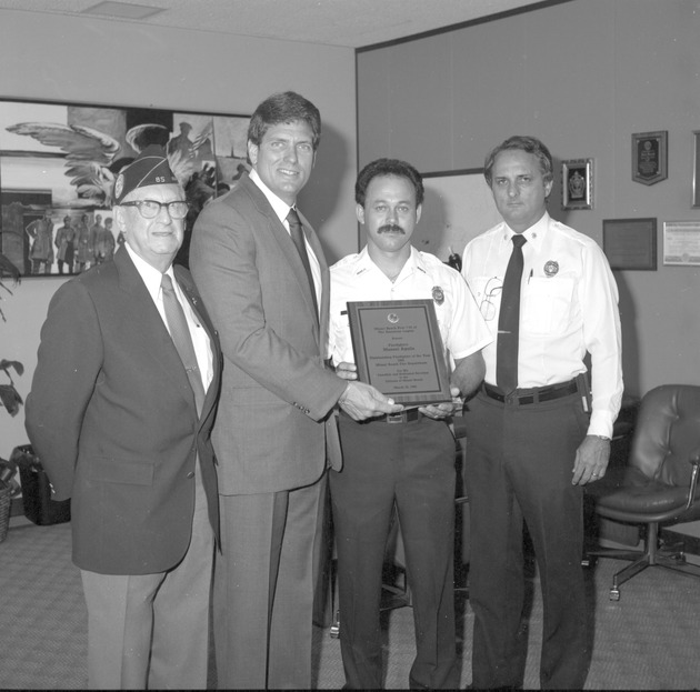Outstanding Awards for 1985 to Firefighter Manuel Aguila, Officer Richard Mendoza, and unnamed woman, from American Legion Miami Beach Post #85 - Award ceremony attendees and recipients 1