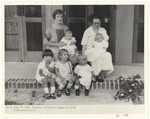 Two women and several young children on Community Church steps