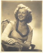 [1950] Photo portrait of seated, smiling woman
