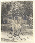 Photo proof of a woman riding a bicycle in her bathing suit