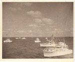 Several center console fishing boats on the ocean