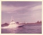 [1950] Center console fishing boat on the water near land
