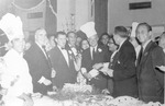 General Dwight Eisenhower wearing chef hat at a cake cutting