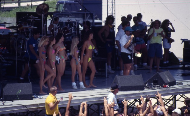 Women in bikinis on stage - Women wearing bikinis posing on stage. 1