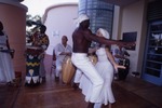Man and woman dancing in front of conga drums