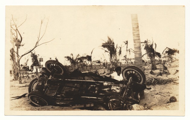 Buick Coupe upside down and half buried in the sand located south of 33rd Street and Collins - Recto Photograph