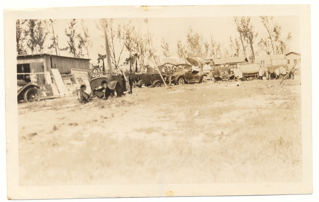 Various automobiles parked rear of Shorty's Garage - Recto Photograph