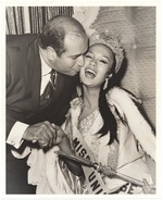 Miss Universe getting a kiss on the cheek