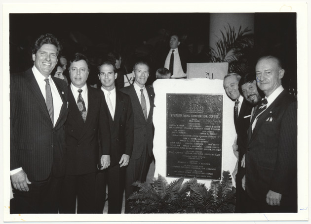 Mayor Daoud and other officials standing with the Stephen Muss Convention Center plaque - Recto Photograph
