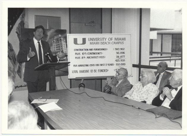 Mayor Daoud with sign showing University of Miami Beach campus funding - Recto Photograph