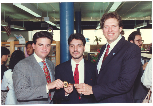 Mayor Daoud and others holding a key to the city in a library - Recto Photograph