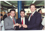 [1980/1990] Mayor Daoud and others holding a key to the city in a library