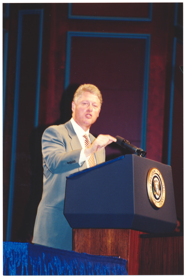 President Clinton on stage at a podium - New Page