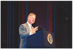 President Clinton on stage at a podium