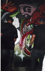 Graffiti artist creating wall
