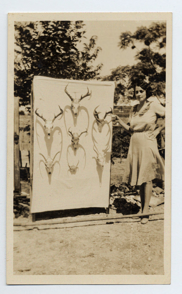 Deer skulls as trophies from a hunting trip on the Keys - (5) An unidentified woman poses with the deer skulls