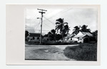 An unidentified dirt street with standing water