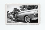 Josephine Perez standing by Dodge Sedan
