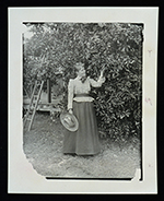 Mary Barr Munroe standing by a lime tree, ca. 1890.