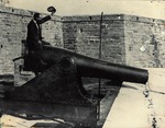 [1890] A man straddling a canon and waving a hat on the east side of the Castillo de San Marcos, looking Northwest, ca. 1890