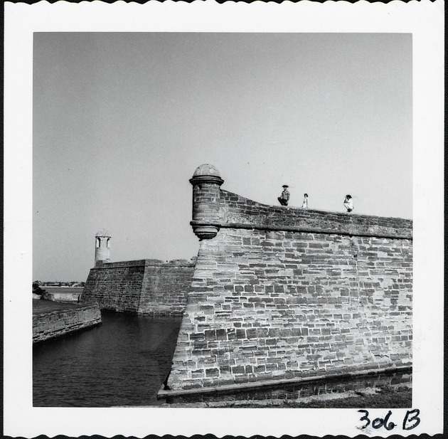 The northwest bastion of the Castillo de San Marcos, with people standing on the terreplein, and the northeast bastion behind, looking East, ca. 1960