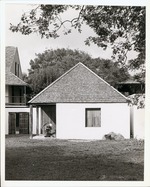 [Gonzales House from rear yard, closed with interpreter in period dress gathering items, looking West]