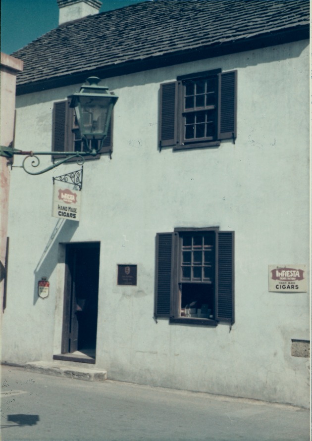 [Oliveros House with sign for "Roberto Camino Hand Made Cigars" from St. George Street, looking East, 1970] - 