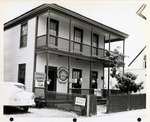 [Cerveau House with Straw Market sign and wares out front, from Cuna Street, looking Northeast]