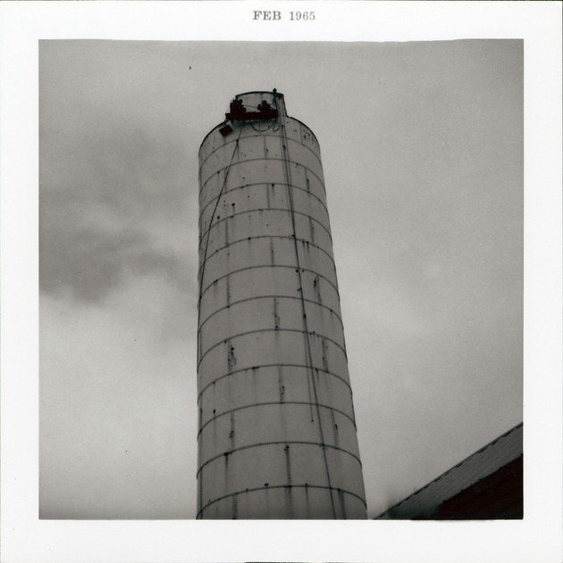 [Water tower on back of Block 8 Lot 3 (currently Tocques parking lot) prior to construction of Pan American Building, 1965] - 