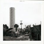 [Water tower and demolition debris on back of Block 8 Lot 3 (currently Tocques parking lot) prior to construction of Pan American Building, looking South, 1965]
