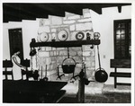 [Casa del Hidalgo interior, showing fireplace and associated artifacts with hostess Maria Hugas Acebal]