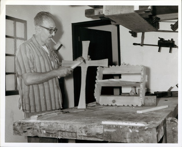 [Santoya House interior, man making cabinets and smoking a cigar] - 