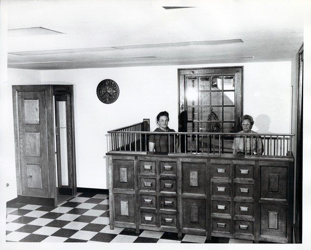 Herrera House interior, Southern Bell Telephone staff at front desk, 1967