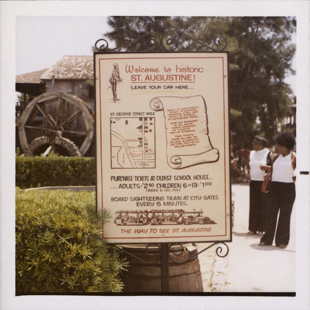 Sign for Sightseeing Trains at the Oldest School House parking lot, looking South