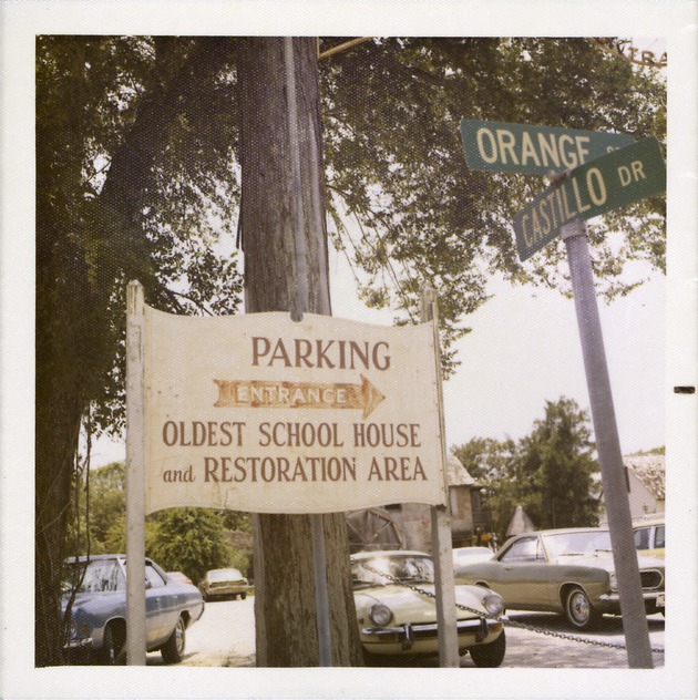 Sign for Oldest School House parking lot from the corner of Orange Street and South Castillo Drive, looking South