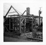 Construction of the Old Blacksmith Shop from Cuna Street, framing the structure, looking Southeast, 1967