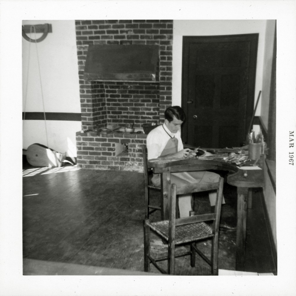 Sims House interior, silversmith at work with furnace in background, 1967