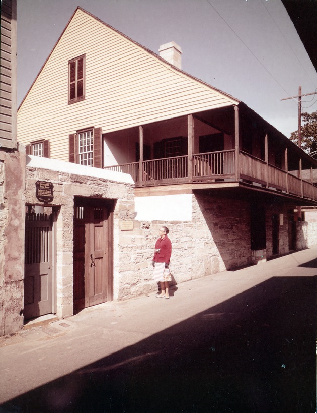 Arrivas House from St. George Street with door closed and woman standing in front, looking Northwest
