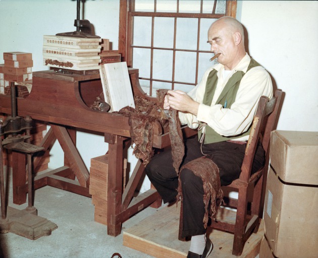 Roberto Camino in period dress rolling cigars in the tobacco shop in the Salcedo House