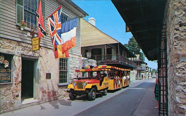 The Rodriguez-Avero-Sanchez House and Arrivas House on the left with a sightseeing trolley in front, from St. George Street, looking North - 