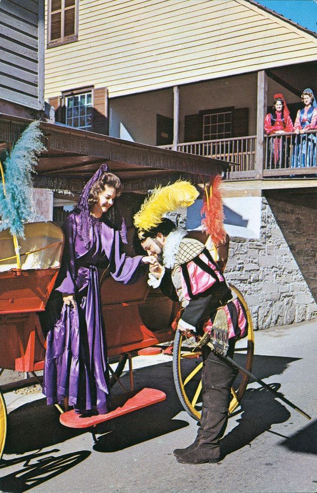 A scene in historic costume: a man kisses a woman's hand as he helps her out of a carriage on St. George Street, while two women watch from the balcony of the Arrivas House, looking Northwest - 